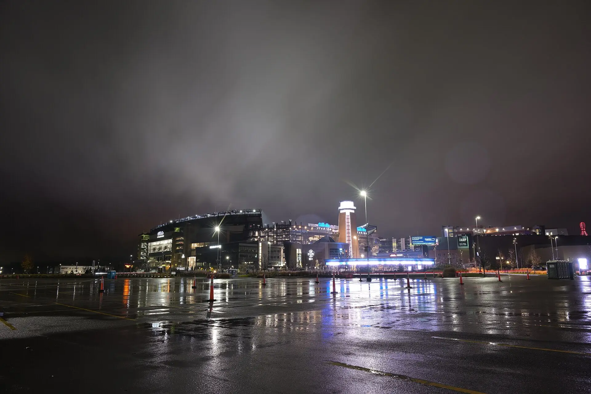 Gillette Stadium lit up at night in the rain, seen from the northeast, late November 2025